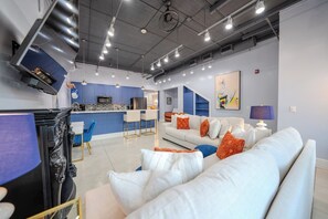 Beautifully decorated living room, with plenty of seating and a designated workspace if you’re traveling for work. 75” Roku TV (must log into your own accounts), fully stocked kitchen with large island and four barstools.