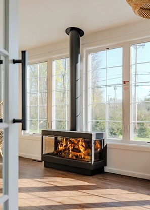 This electric fireplace fills the sun room with warmth and creates a cozy ambience immediately upon stepping into the home.
