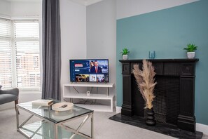 Enjoy your favorite shows on the modern TV, or cozy up by the fireplace, adding warmth and charm to the room.