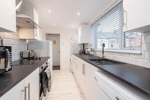 Enter our spacious kitchen, equipped with modern facilities to enhance your culinary experience.