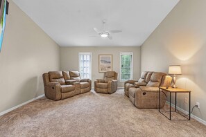 Relax and unwind in the cozy living room with comfortable recliners and warm lighting!