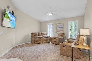 Unwind in the cozy living room with plush seating and a large-screen TV for your entertainment!