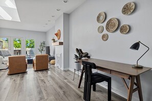 Welcome to Lighthouse Lookout, where the natural light pours in through the skylight, illuminating the beauty of the wooden floors.