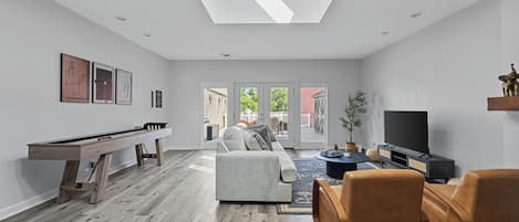 This space is all about relaxation and fun, from cozy couches to game-ready shuffleboard.
