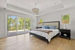 Rise and shine! There's nothing quite like waking up in a cozy bedroom with a large bed and a sliding glass door.