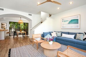 From the rattan armchairs to the ocean-hued sofa, every detail in this living room whispers relaxed coastal luxury    NPG-C11