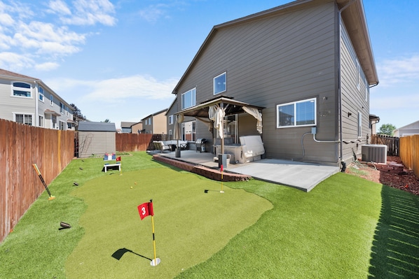 Our beautiful yard with Mini golf course, comfortable seating, grill, firepit and Hot Tub!