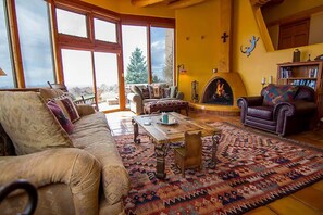 The cozy living room with wood burning fireplace.
