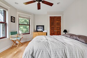Second-floor south-facing bedroom has down comforter and ample closet space.
