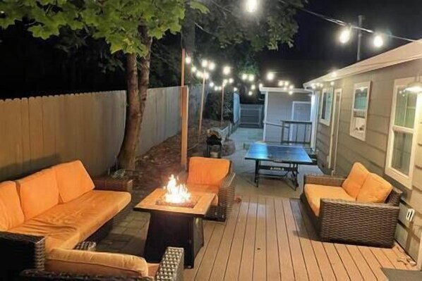 Outside patio with ping pong table and fire pit