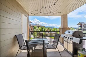 Private patio with a BBQ and pool & mountain views.