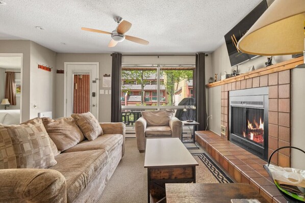 Living room with a 46" Smart TV with cable, two pull-out sofa beds (1 queen & 1 single) & decorative fireplace (glow logs only, please!)