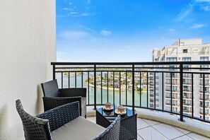 The primary bedroom features a second balcony framing spectacular vistas across the river.