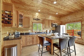 Open kitchen and living space with natural light and scenic views