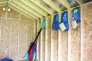 Life jackets and paddles stored in the shed