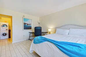 Master bedroom with king size bed and workspace a perfect blend of comfort and productivity.