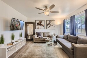 Walk into a Sophisticated living room design with two sofas that open up to full-size beds, 60” Smart TV, full-length mirrors, beautiful decor, and much more.