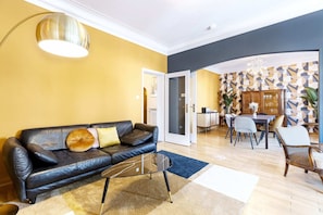 Stylish and comfortable living room with modern decor, perfect for unwinding with a book or enjoying a movie night.