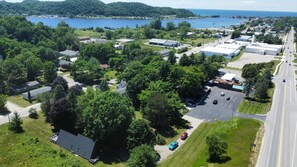 OVERALL:  Aerial view showing the chalet in the lower left with Betsie Lake at the top, downtown Frankfort at the right, and Lake Michigan in the distance