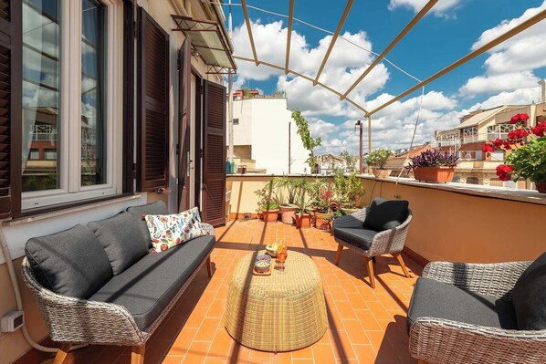 Spacious outdoor terrace at the beautiful Coppedè apartment in Rome.