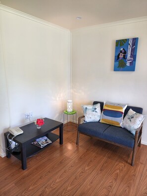 Open plan sitting/dining with a 2 seater sofa 