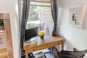 Workspace with desk, chair, monitor, and printer
