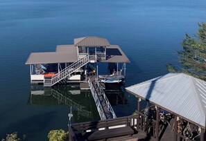 The dock for swimming and fishing with fishing gear, floats, kayaks, and paddle boards for complimentary guest use.  