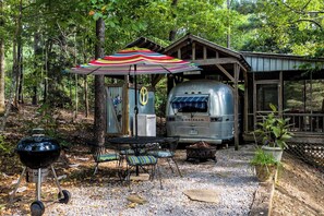 ToNoMo Airstream with outdoor shower, outdoor patio with grill, firepit, table and chairs; and screen porch.  Private location near lakeshore.  Access to swimming, kayaks and paddleboards on large dock.