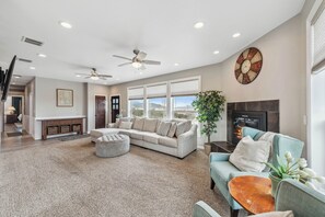 Spacious yet cozy, the living room is perfect for gathering and relaxing. Featuring a 75” TV, a large sectional with a roomy ottoman, and additional armchairs, there’s plenty of space for everyone to kick back. The welcoming entrance sets the tone for a warm and comfortable stay.