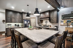 This fully equipped kitchen features a spacious island, perfect for meal prep and entertaining.