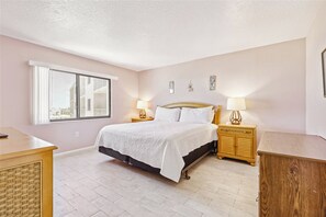 Master bedroom with king size bed, soft neutral tones, and a peaceful, inviting ambiance.