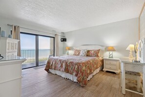 Cozy bedroom with king bed, soft lighting and ocean views for peaceful mornings