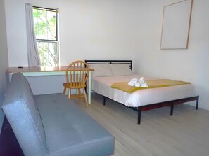 The main bedroom features queen bed, an en-suite bathroom, and a work station. 
