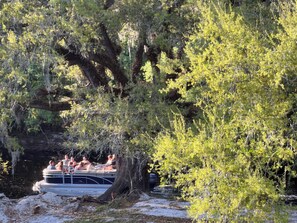 Fishing boat and tourist boats often pass through in the creek of backyard