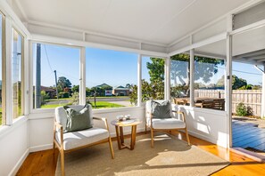 Sunroom: stunning extra seating , reading room , blackout blinds.