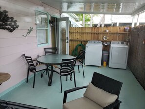 Covered seating area on enclosed private patio area. 