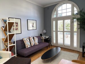 Large Living Area with ample Lounge Seating. The French Doors open to a Juliet Balcony with elevated Street & City Views. The Apartment has reverse-cycle Air-conditioning but there is an overhead Ceiling Fan in this area if you prefer fresh air. 