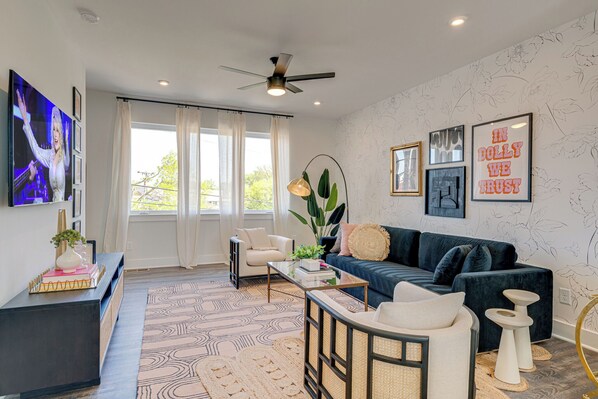 Bright and open living space complete with designer furnishings and smart TV.