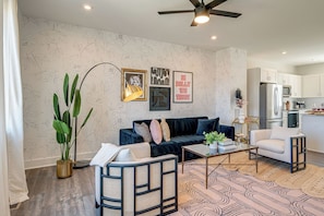 Bright and open living space complete with designer furnishings and smart TV.