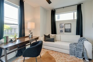 Common space with queen sleeper sofa and desk