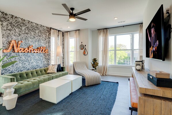 Bright and open living space complete with designer furnishings and smart TV.