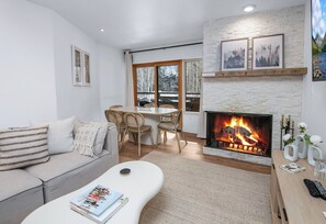 Living Room w/ Fireplace & Dining Room