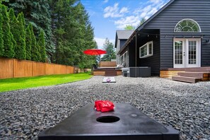 Bag toss w/ outdoor sectional in the background & string lights set on a timer!