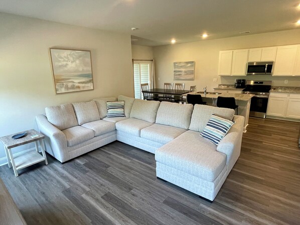 open concept living room with large sectional sofa.