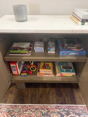 Kids books, Card Games, Coloring Book, Connect 4, Jenga under coffee table