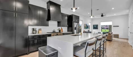 Get ready to eat with a large fully stocked kitchen including island with bar stool seating
