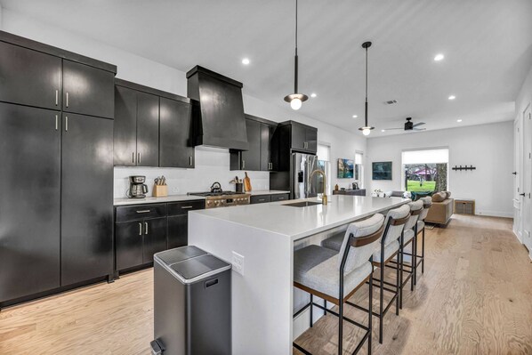 Get ready to eat with a large fully stocked kitchen including island with bar stool seating