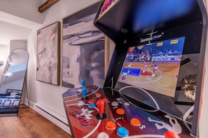 Unleash your competitive spirit with our NBA Jam arcade machine! Tucked in a cozy corner of our stylish game room, this vintage-style arcade is a blast from the past and perfect for game night.
