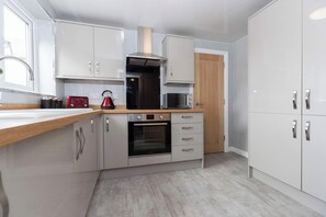 Kitchen on the first floor next to bathroom and dining room