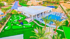 Estate Aerial View
Description: Stunning aerial shot showcasing the full scale of the estate, lush landscaping, modern architecture, and outdoor amenities.